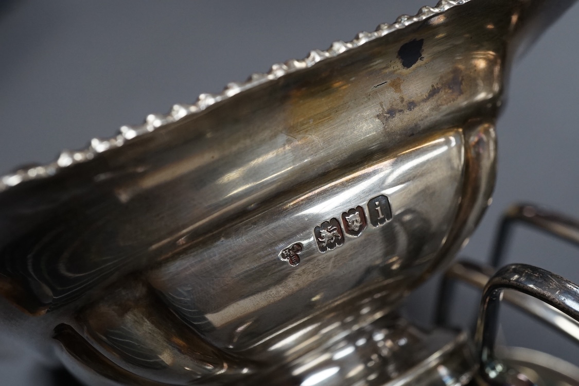 A pair of George V silver five bar toast racks, by Atkin Brothers, Sheffield, 1912, length 94mm, together with a silver muffin dish lid and a silver pedestal bonbon dish, 26.2ox